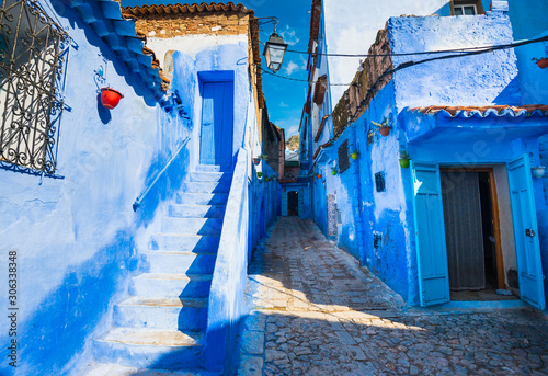 Narrow street of Chefchaouen city in Morocco with blue walls, doors and stairs © leelook