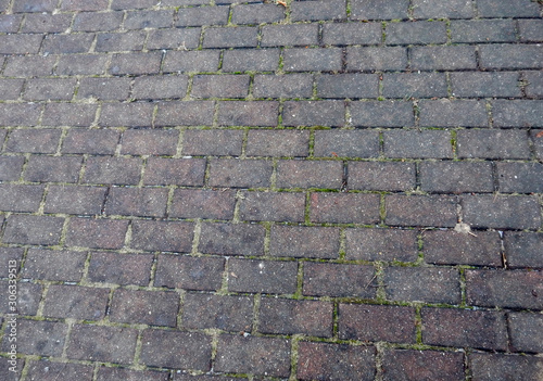 red stone paved road and brick wall