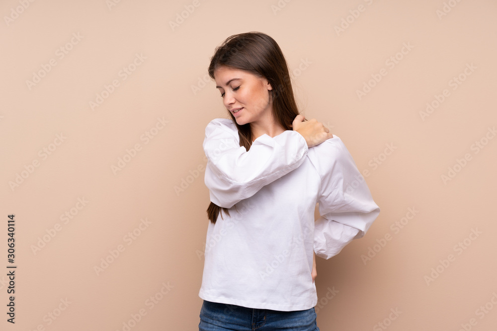 Young girl over isolated background suffering from pain in shoulder for having made an effort Young girl over isolated background suffering from pain in shoulder for having made an effort