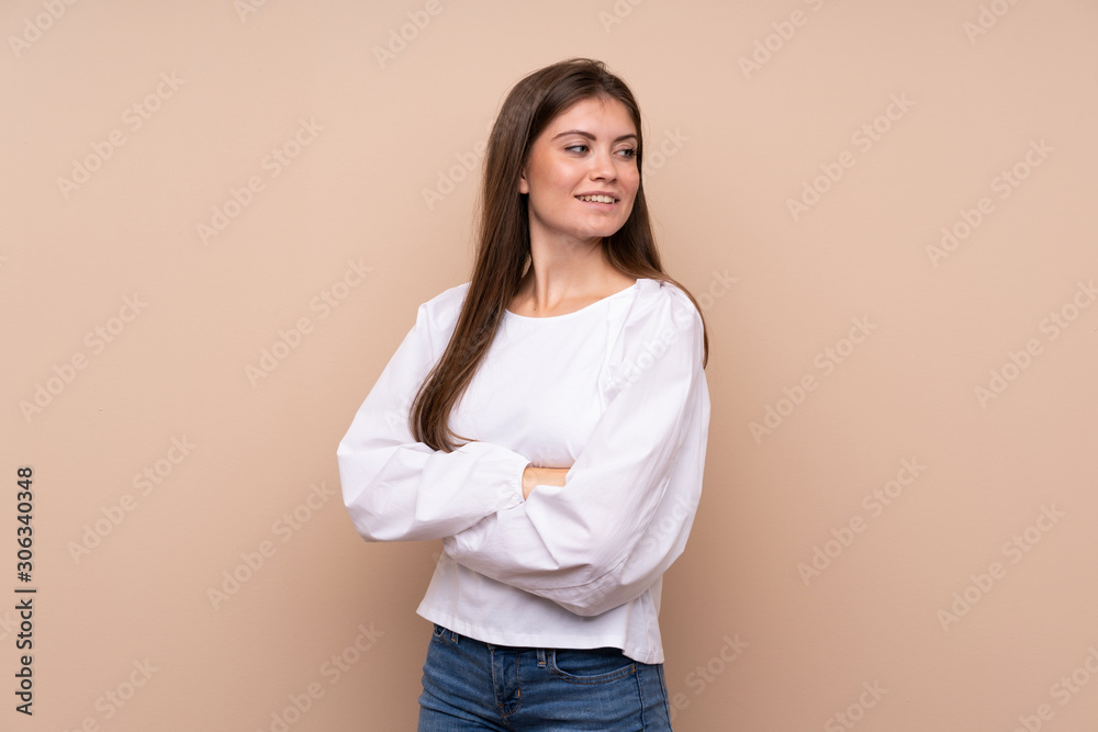 Young girl over isolated background with arms crossed and happy Young girl over isolated background with arms crossed and happy