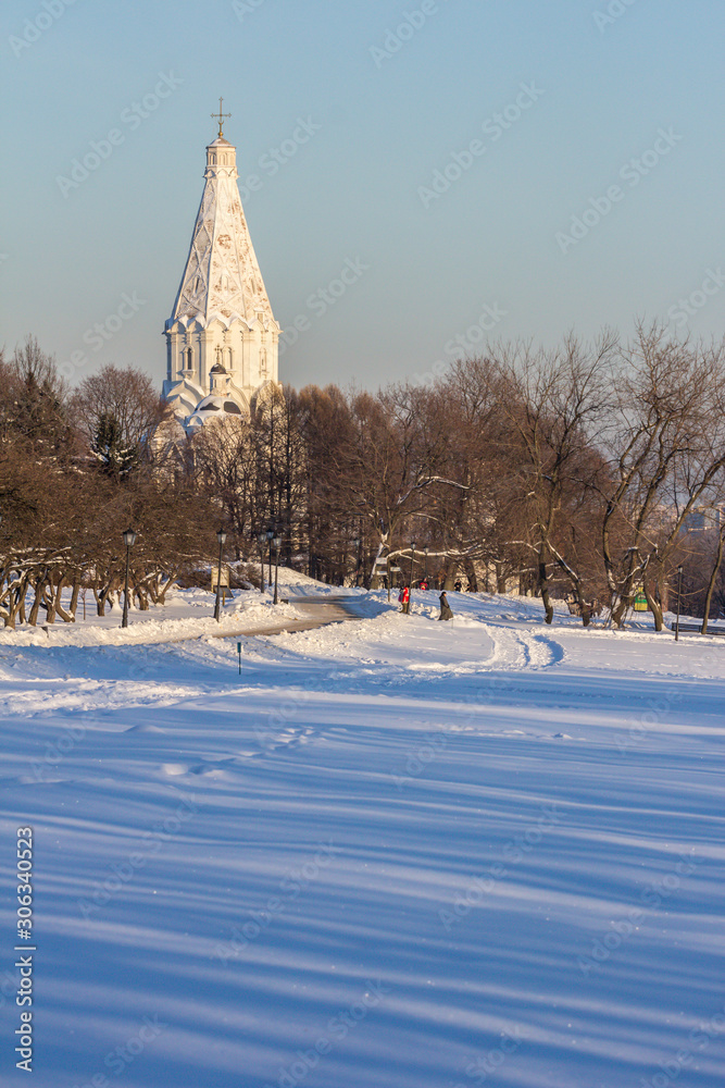 Moscow, Russia. Winter landscape with a white church (from unesco world heritage) in the Kolomenskoye park, blur and grain effect.