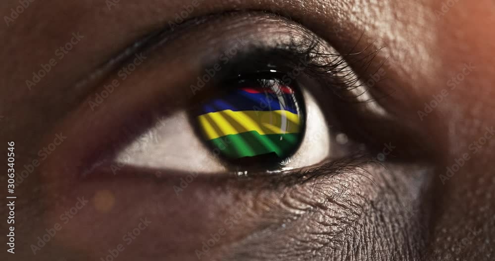 Woman black eye in close up with the flag of Mauritius in iris with wind motion. video concept