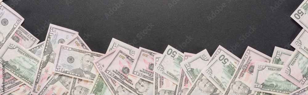 top view of scattered dollar banknotes on grey background, panoramic shot top view of scattered dollar banknotes on grey background, panoramic shot