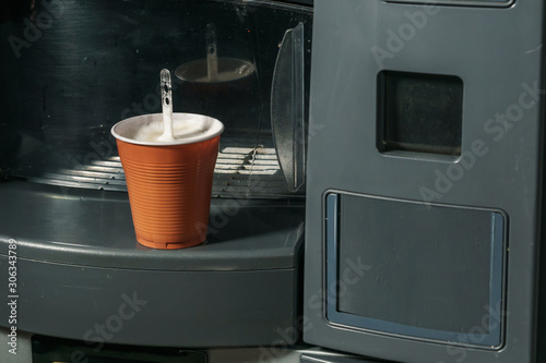 coffee from a vending machine in a plastic cup photo