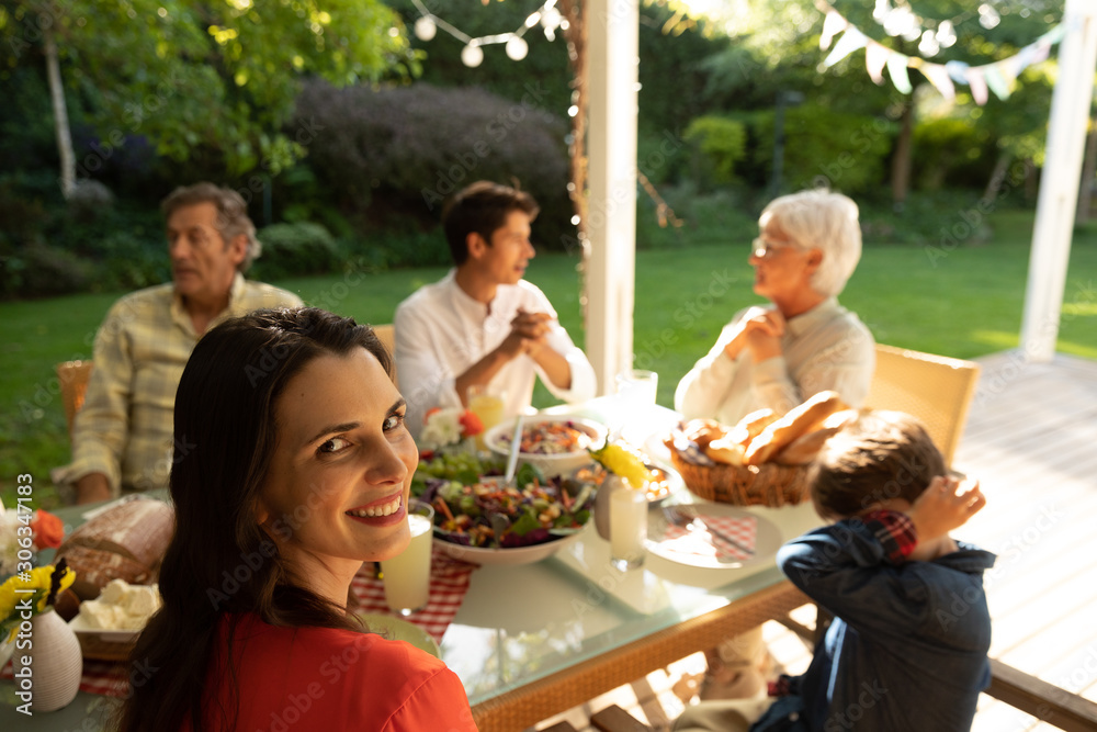Obraz premium Family eating outside together in summer