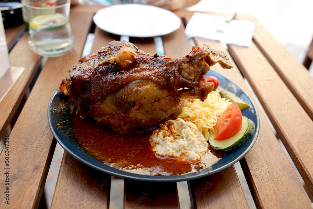 Traditional Czech dinner with fried pork leg and beer in a restaurant.   Travel and vacation. Close up