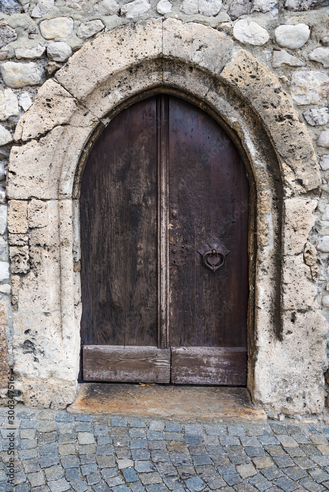 old wooden door of church in hall in tyrol