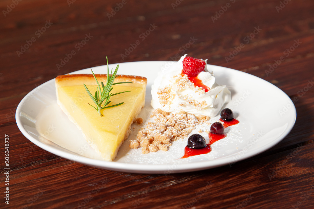 Fresh tasty lemon tart with crumble and whipped cream