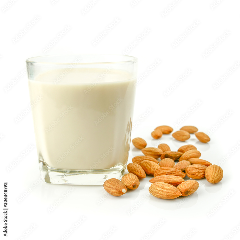 almond kernel and almond milk in the glass isolated on white background almond kernel and almond milk in the glass isolated on white background