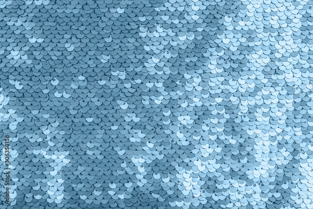 Sky blue shiny fabric with sequins, abstract background.