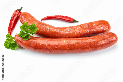 several raw merguez on a white background