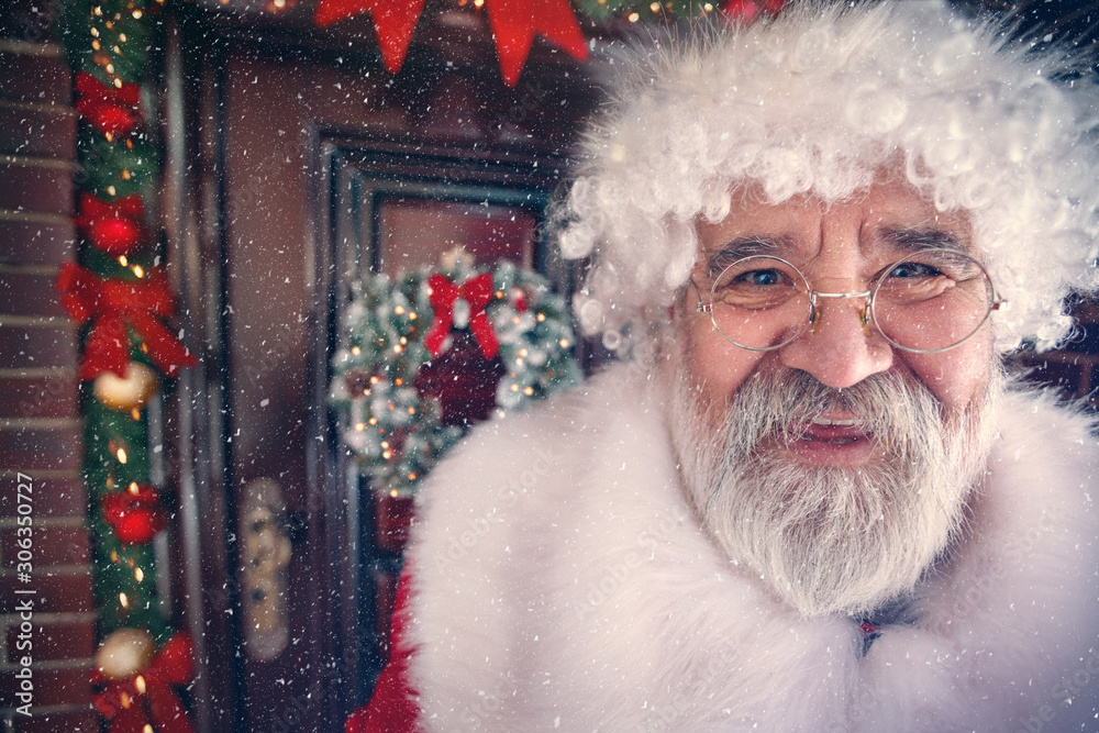 Funny smiling Santa Claus at Christmas time in front of door Funny smiling Santa Claus at Christmas time in front of door