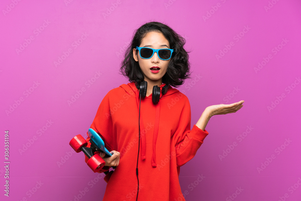 Asian young girl with skate over purple background Asian young girl with skate over purple background