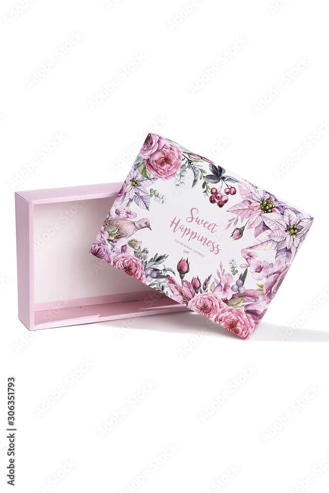 Subject shot of a white gift box with a white bottom and a lid decorated with colorful floral tropic print, design with letters and a pleasant text: 
