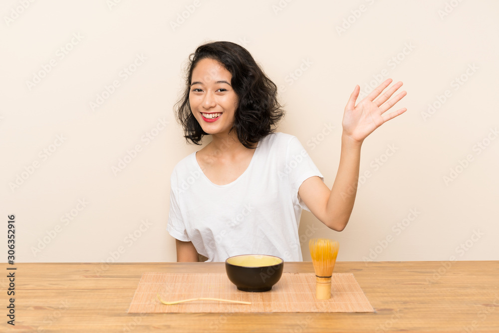 Young asian girl with tea matcha saluting with hand with happy expression Young asian girl with tea matcha saluting with hand with happy expression