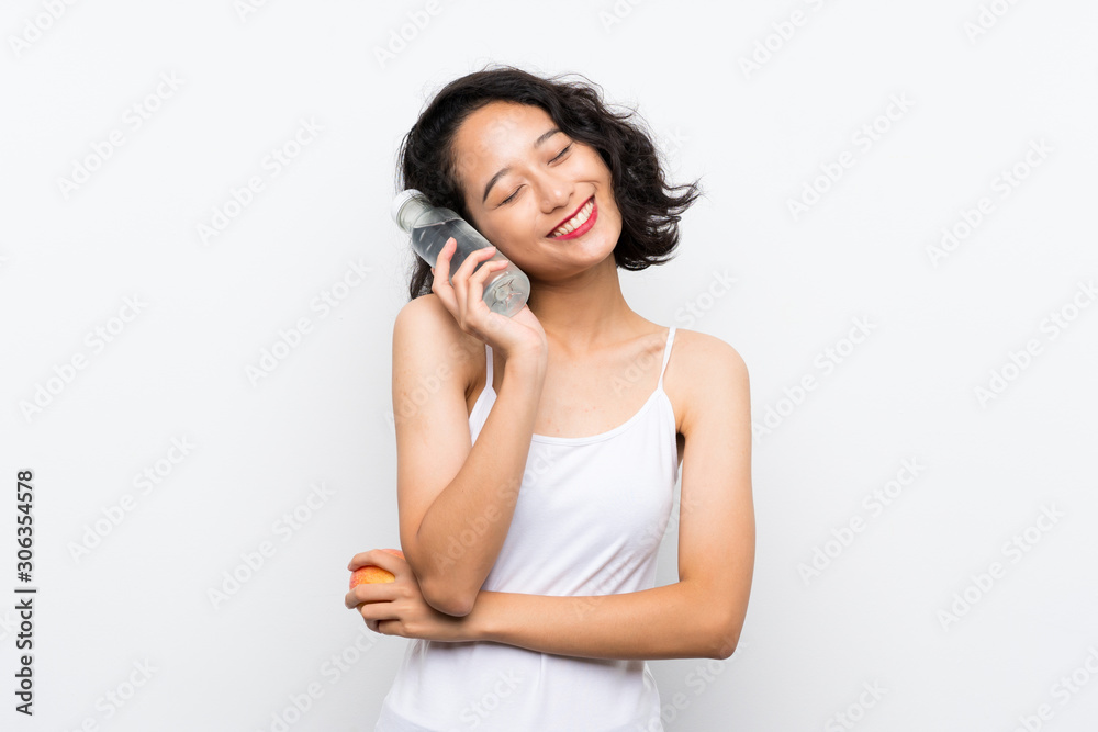 Asian young woman with an apple over isolated white background Asian young woman with an apple over isolated white background