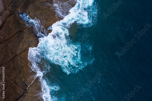 Top view of a deserted coast. Rocky shore of the island of Tenerife. Aerial drone photo of ocean waves reaching shore