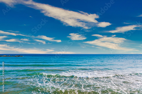 Beautiful clean blue sky  clouds  sea or ocean and waves at the beach in sunny day at summer time season. Sea and sky background. 