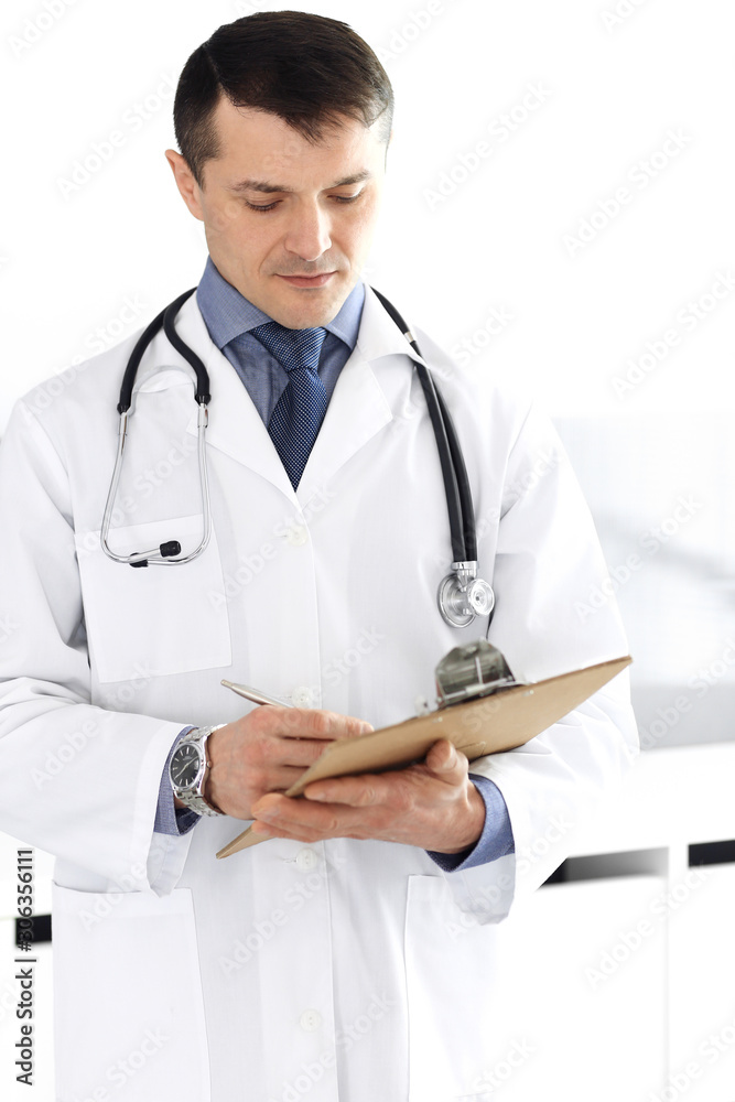 Doctor man using clipboard for filling up medication history records. Perfect medical service in clinic. Physician at work in hospital. Medicine and healthcare concepts Doctor man using clipboard for filling up medication history records. Perfect medical service in clinic. Physician at work in hospital. Medicine and healthcare concepts