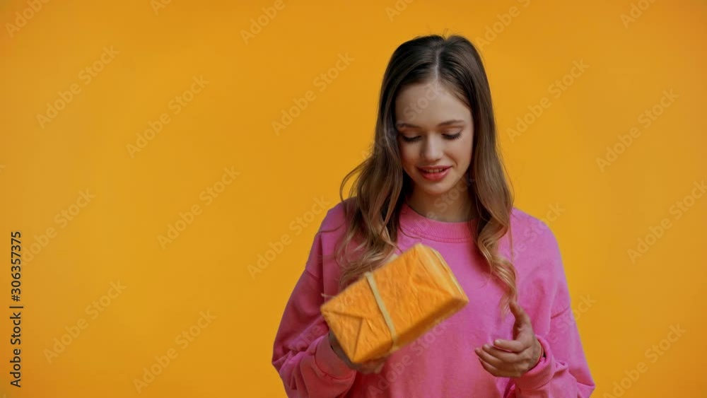 teenager getting gift and toy isolated on yellow teenager getting gift and toy isolated on yellow