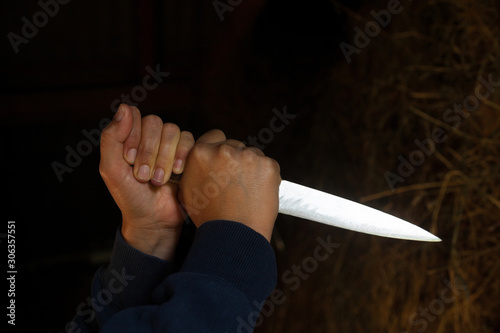 Hands holding a big sharp knife