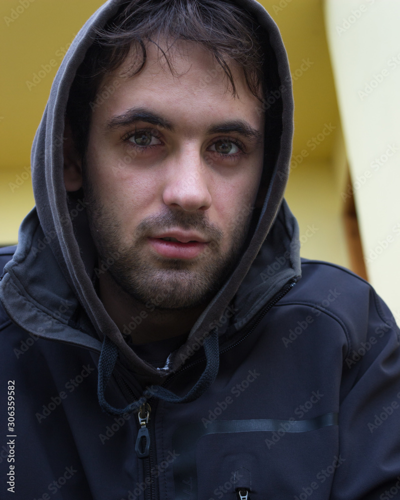 Young white boy with black hoodie and short beard. Young white boy with black hoodie and short beard.