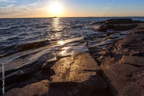 ancient rock carvings petroglyphs on the shore of Onega Lake carved on a granite plate . Age of object - 5000-6000 years. Cape Besov Nos, Karelia, Russia. photo