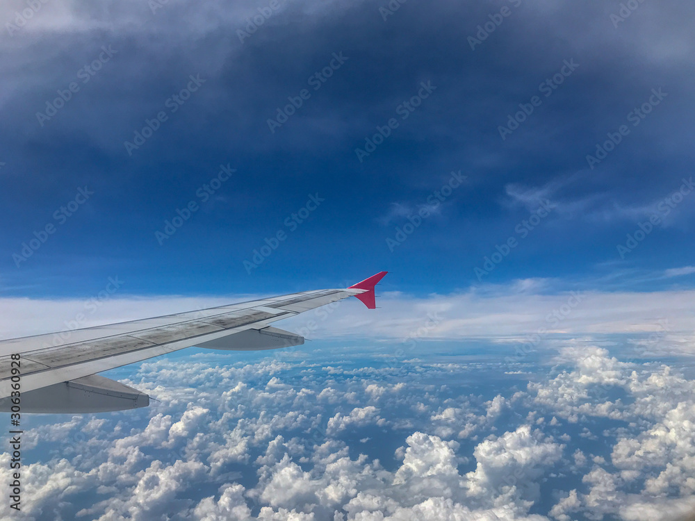 Airplane Window View of Wing and clear blue sky Airplane Window View of Wing and clear blue sky
