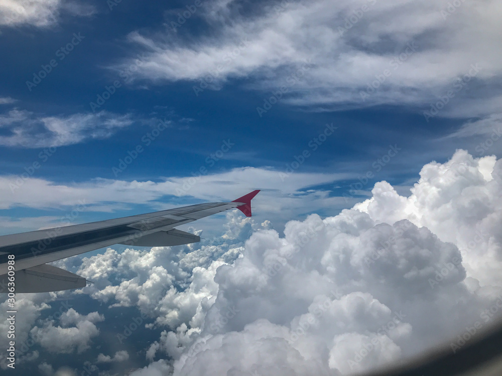 Fototapeta premium Airplane Window View of Wing and clear blue sky
