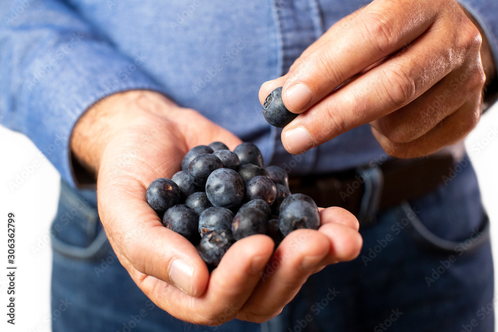 Close Up Studio Shot Of Man Eating Fresh Blueberries Close Up Studio Shot Of Man Eating Fresh Blueberries