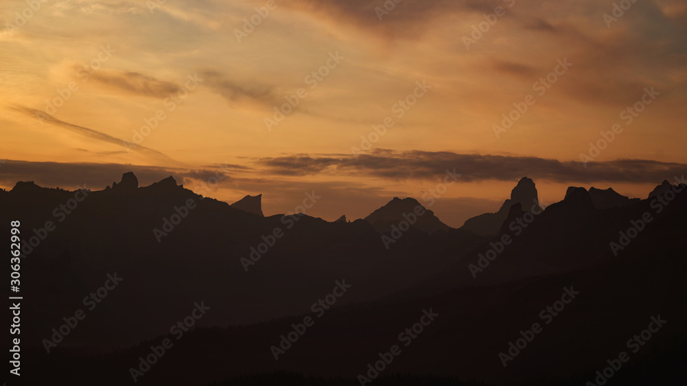 outline of mountains in shadow at dawn