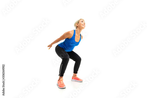 European sports blonde girl crouches on a white background