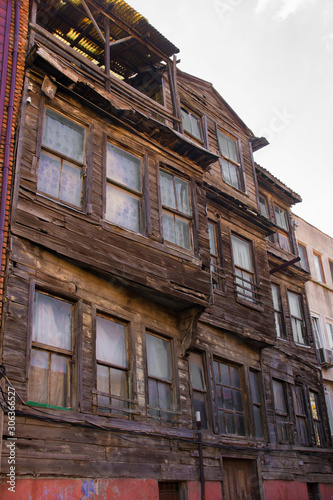 Traditional historic wooden buildings stand semi-derelict in the Zeyrek district of Fatih, Istanbul © dragoncello