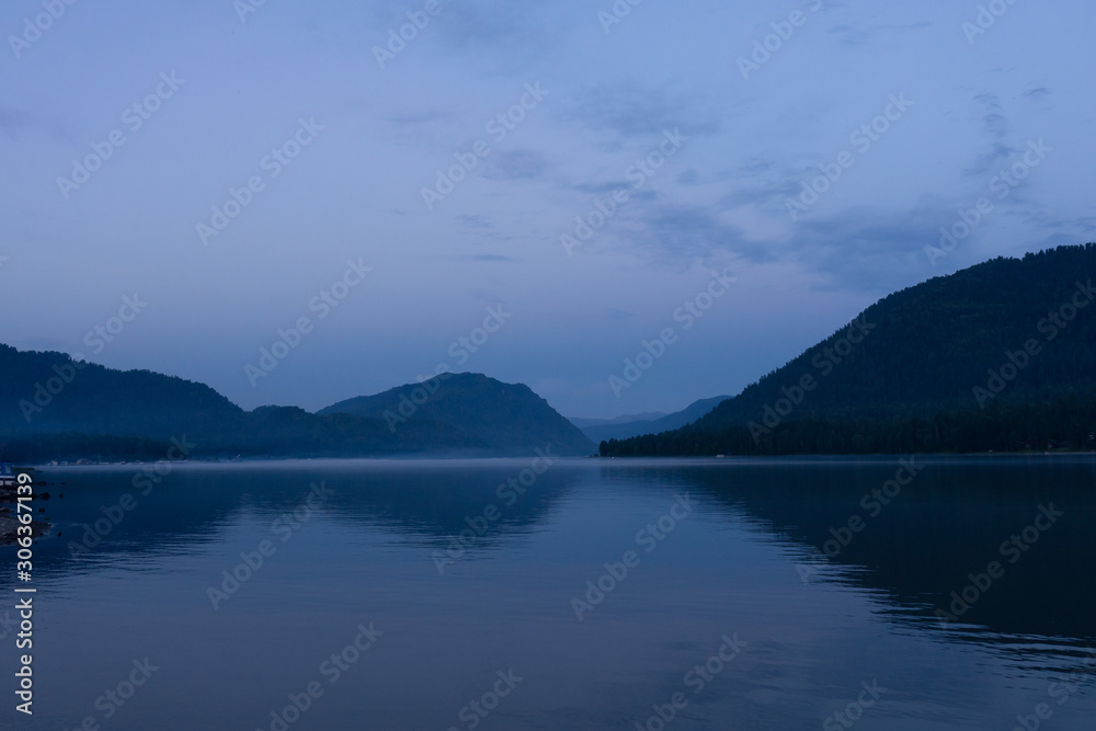 Lake Teletskoye in the mountains. In the evening you can see the hills and nature. Altai region