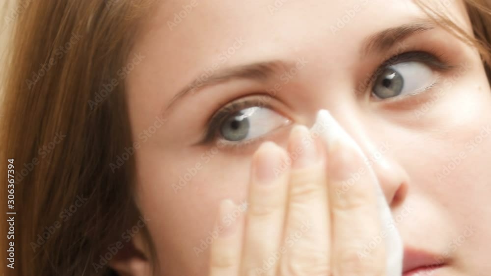 beautiful cute girl corrects makeup by wiping his face with a napkin, a concept of female natural beauty and cosmetics beautiful cute girl corrects makeup by wiping his face with a napkin, a concept of female natural beauty and cosmetics