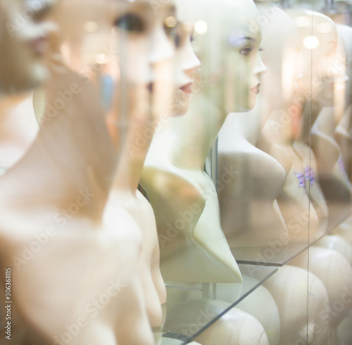 Naked female mannequins in the shop window.