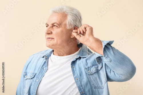 Mature man with hearing aid...