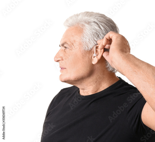 Mature man with hearing aid...