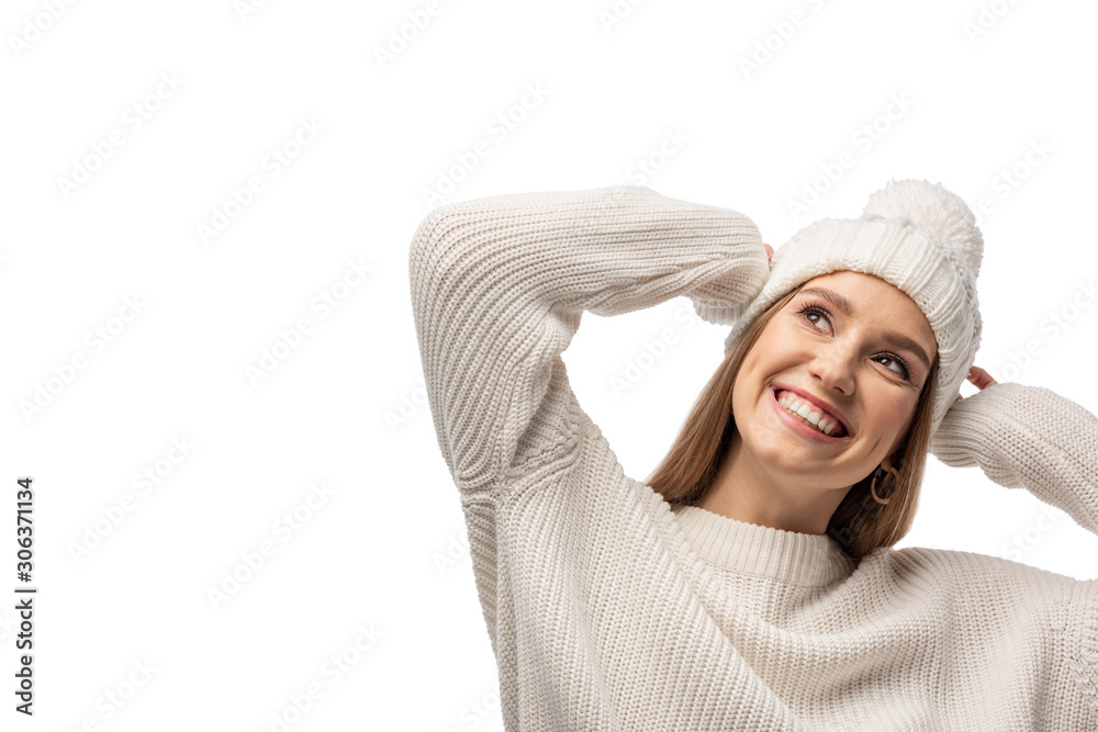 attractive smiling girl posing in white knitted sweater and hat, isolated on white attractive smiling girl posing in white knitted sweater and hat, isolated on white