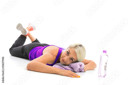 girl in a sports uniform lies on a yoga mat with a towel isolated white background