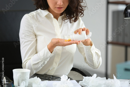 Sick woman taking pills dur...