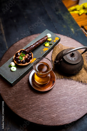 tea in armudu glass, chinese teapot and chocolate tartaleta