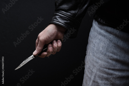 Man brandishing knife in a threatening manner.