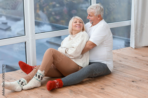 Happy mature couple sitting...