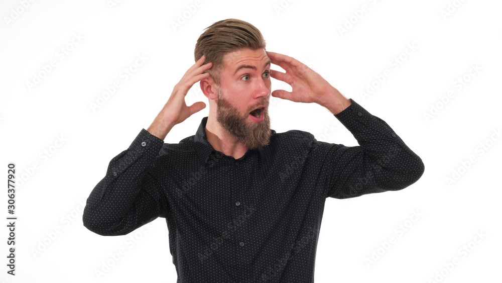 Young adult man with beard and black shirt is full of expression. Young adult man with beard and black shirt is full of expression.