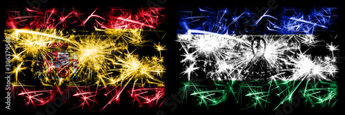 Spanish vs Lesotho New Year celebration sparkling fireworks flags concept background. Combination of two abstract states flags. © Vlad