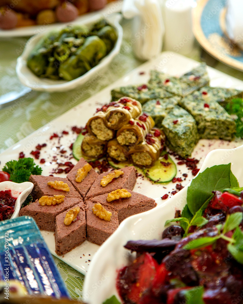 side dish platter with kookoo, aubergine wraps and beetroot salad