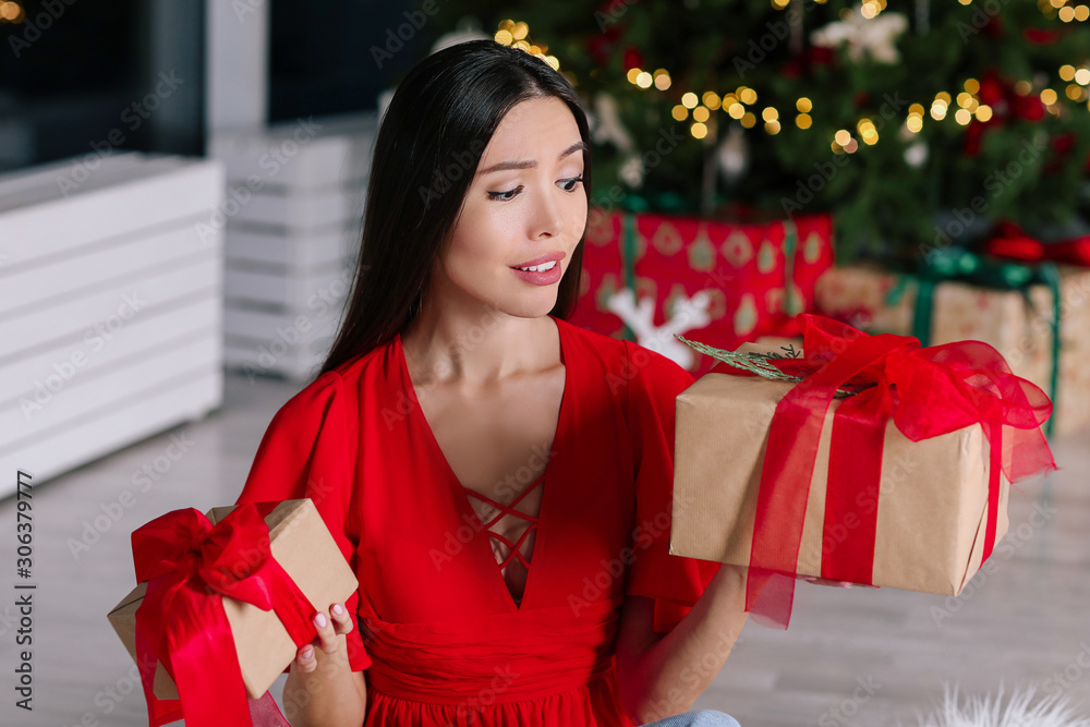 Beautiful Asian woman with Christmas gifts at home Beautiful Asian woman with Christmas gifts at home