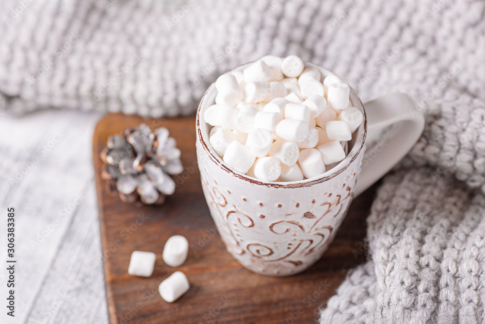 Mug with coffee and marshmallow, sweater, cinnamon. Cozy christmas composition. Hygge concept Soft focus Mug with coffee and marshmallow, sweater, cinnamon. Cozy christmas composition. Hygge concept Soft focus