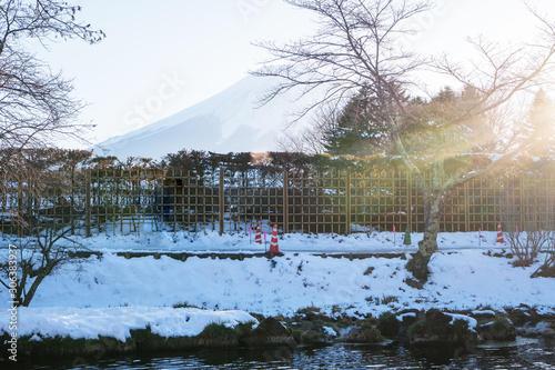 Mount Fuji at Oshino Hakkai in snow fall with River Mineral water, Traditional Japanese style house with mt.fuji, Landmark of life Japan's strong community famous tourist destination village in Japan